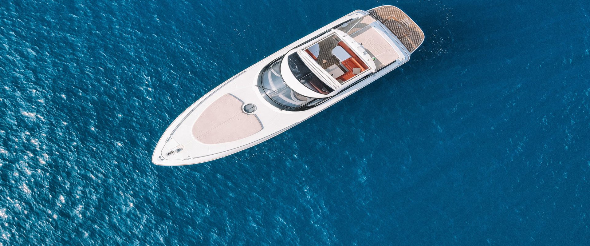 A private catamaran over deep blue Aegean water off Santorini